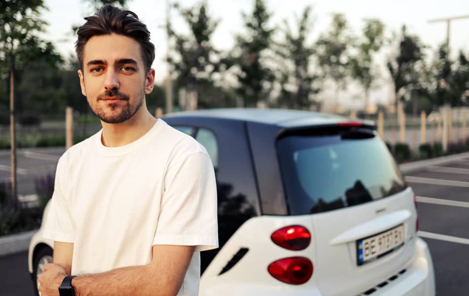 Man Standing by Car Avada Car Dealer News